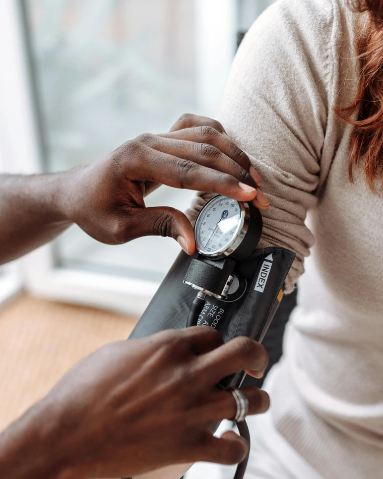 A provider taking a patient's blood pressure