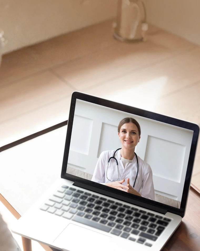 A telehealth visit on a laptop at home